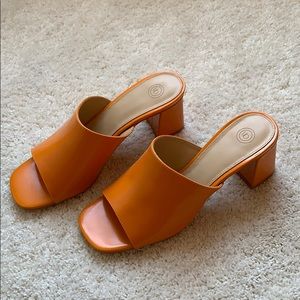 60s-style bright orange mules